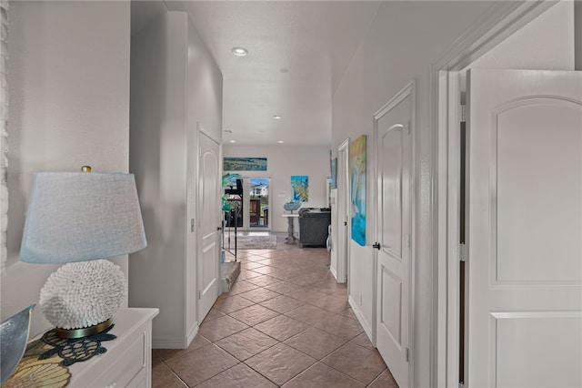 corridor featuring light tile patterned floors