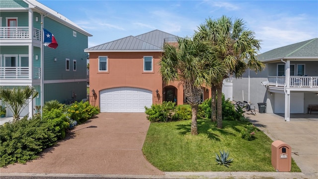 view of front of home featuring a garage, a front yard, and a balcony