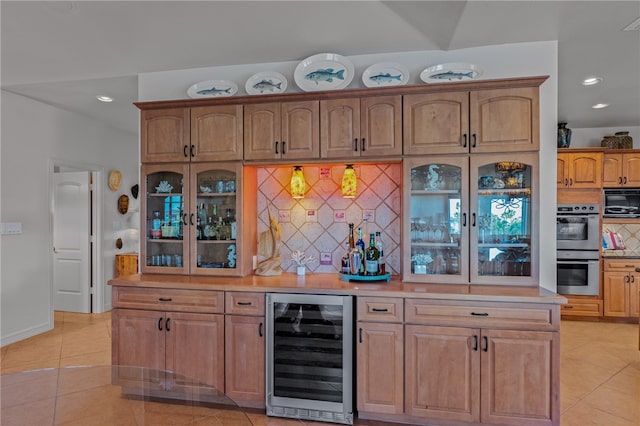 kitchen featuring wine cooler, tasteful backsplash, light tile patterned floors, double oven, and black microwave