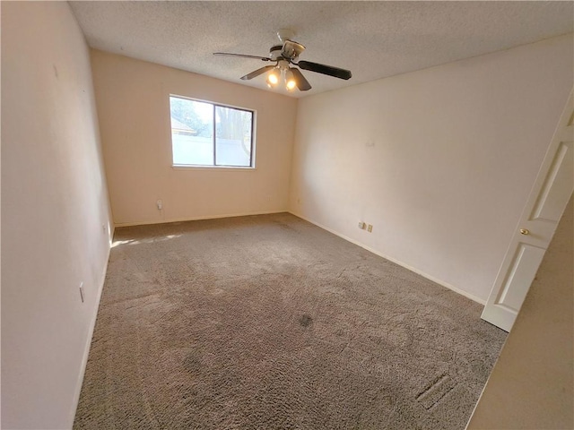 carpeted spare room with ceiling fan and a textured ceiling