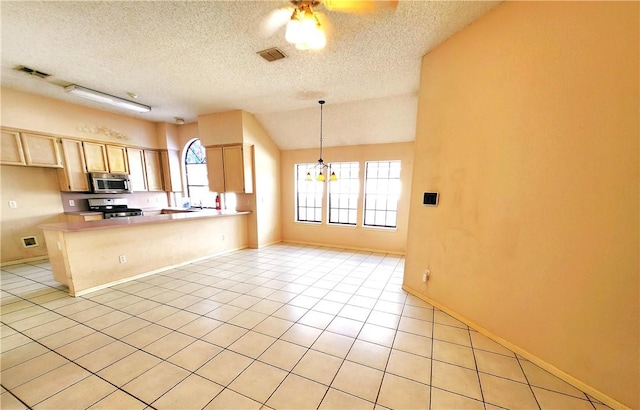 2210 Dorsey St, Corpus Christi, TX 78414 - kitchen featuring appliances with stainless steel finishes, a textured ceiling, light brown cabinetry, a ceiling fan, and a peninsula