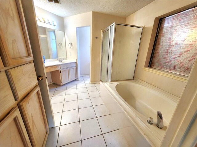 bathroom featuring vanity, shower with separate bathtub, a textured ceiling, and tile patterned flooring