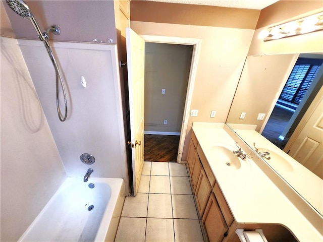 bathroom featuring tile patterned flooring, vanity, and  shower combination