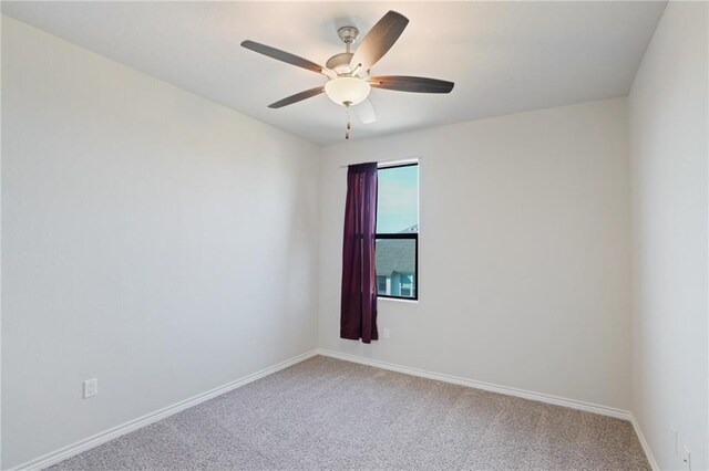 spare room featuring carpet flooring and ceiling fan