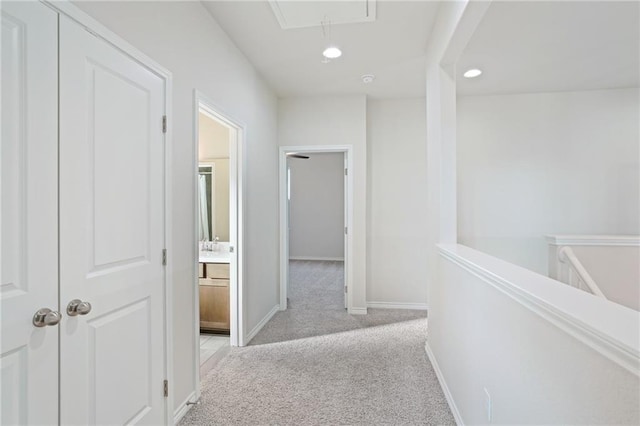 hallway with light colored carpet