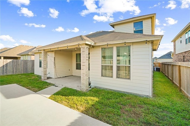 back of property featuring a lawn, central AC unit, and a patio area