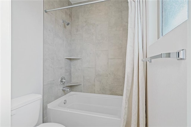 bathroom featuring shower / bath combo and toilet