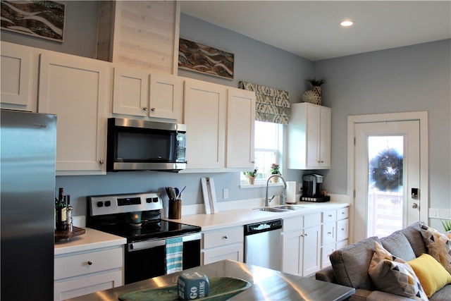 kitchen featuring white cabinetry, sink, and appliances with stainless steel finishes