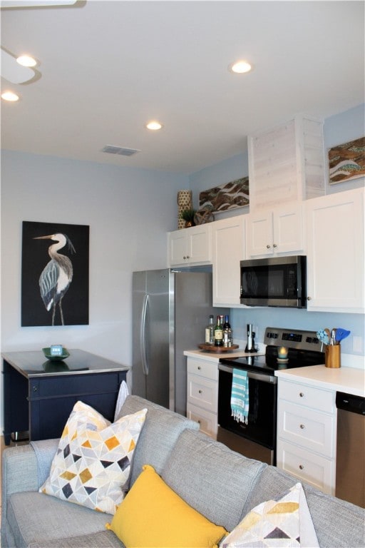 kitchen with white cabinets and appliances with stainless steel finishes