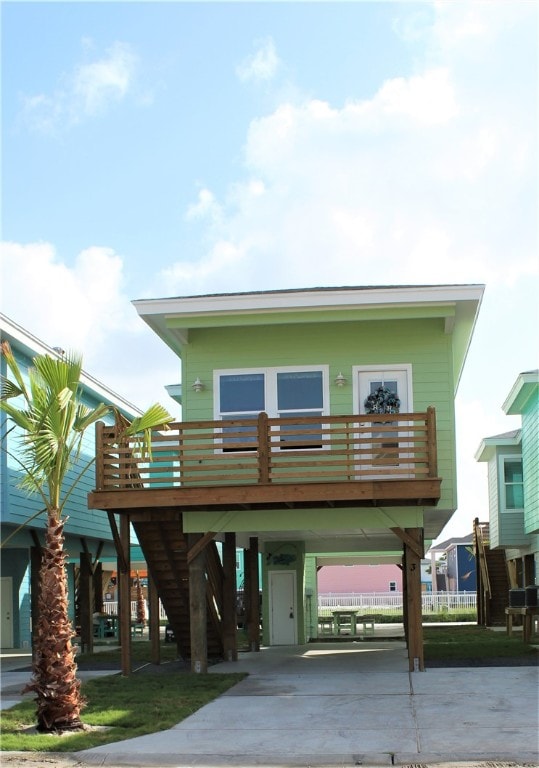 view of front of house with a wooden deck and a carport