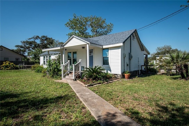 bungalow-style house with a porch, a front yard, and a shingled roof