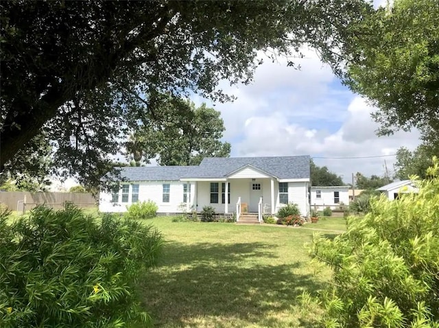 single story home featuring fence and a front lawn