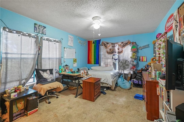 bedroom with carpet floors, a textured ceiling, and a ceiling fan