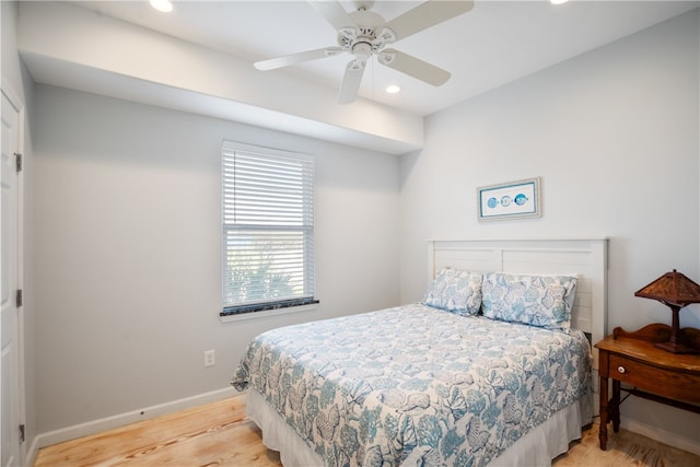 bedroom with light hardwood / wood-style floors and ceiling fan