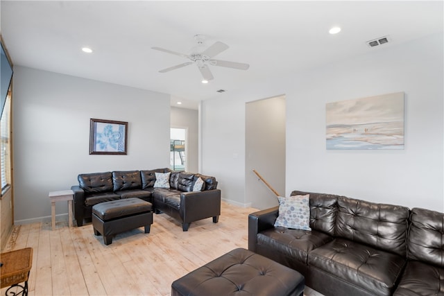 living room featuring light hardwood / wood-style floors and ceiling fan