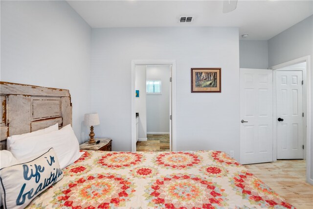 bedroom with light hardwood / wood-style floors and ceiling fan