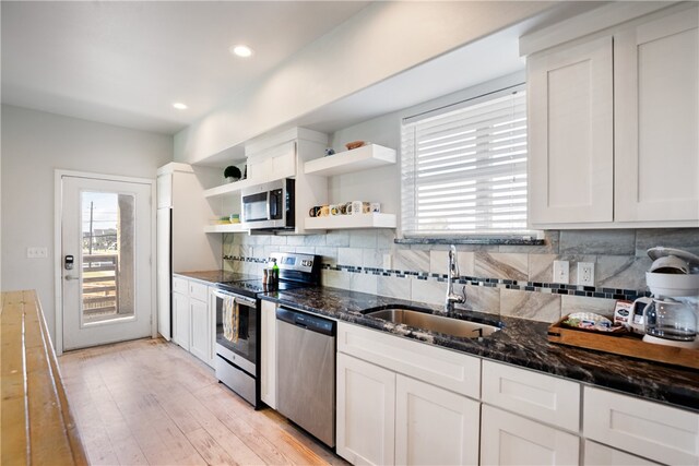 kitchen featuring appliances with stainless steel finishes, sink, and white cabinets