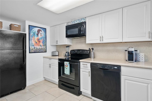 4000 Surfside Blvd Unit 403, Corpus Christi, TX 78402 - kitchen with black appliances, white cabinetry, light countertops, and light tile patterned floors