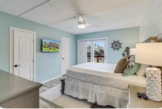 bedroom featuring baseboards, a ceiling fan, access to exterior, and light wood-style flooring