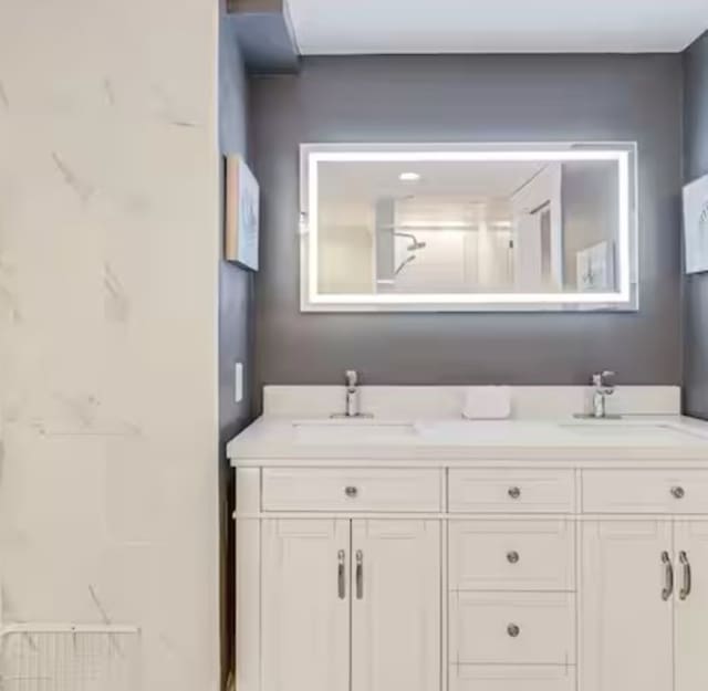 full bath with double vanity and a sink