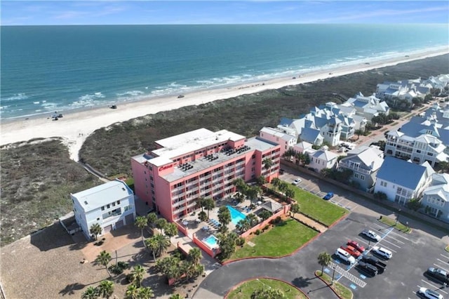 birds eye view of property with a view of the beach and a water view