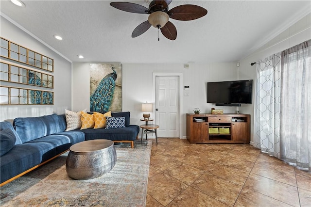 living area with light tile patterned floors, a ceiling fan, recessed lighting, ornamental molding, and a textured ceiling