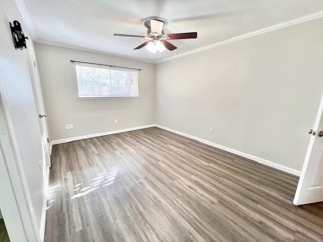 empty room featuring crown molding, dark hardwood / wood-style flooring, and ceiling fan