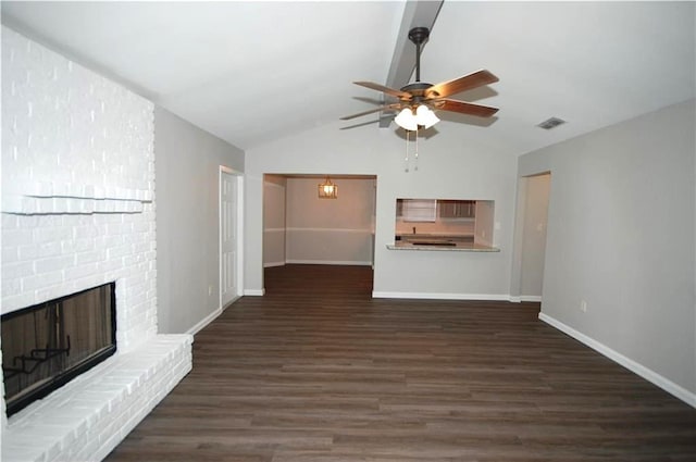 unfurnished living room with dark hardwood / wood-style flooring, ceiling fan, a fireplace, and vaulted ceiling