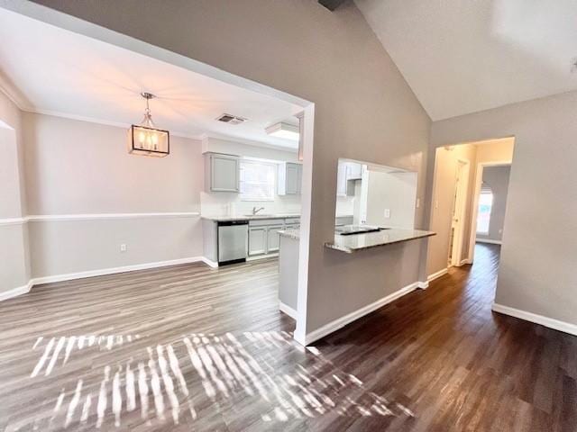 unfurnished living room with a chandelier, dark hardwood / wood-style flooring, vaulted ceiling, and sink