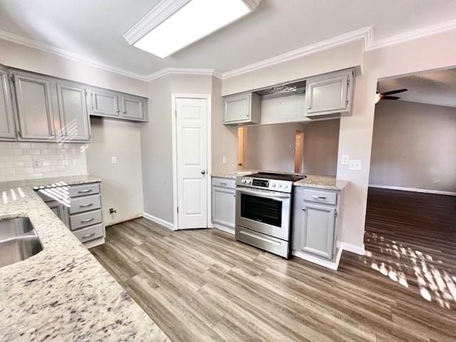 kitchen with gray cabinetry, stainless steel electric range oven, ceiling fan, and light stone countertops