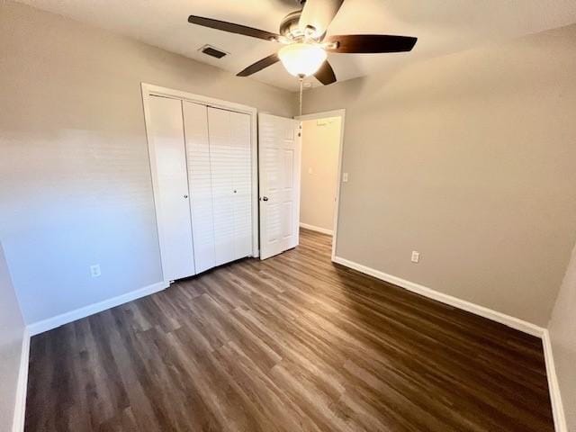 unfurnished bedroom with a closet, ceiling fan, and dark hardwood / wood-style floors