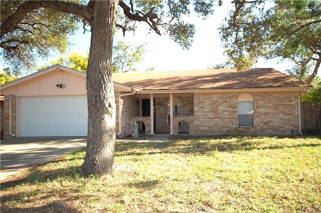 ranch-style home with a garage and a front lawn