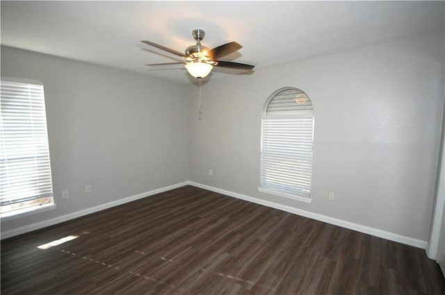 empty room featuring dark hardwood / wood-style flooring and ceiling fan