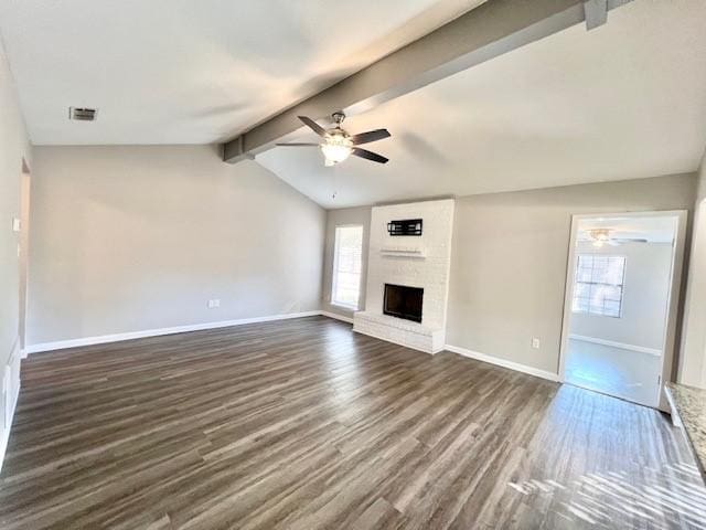 unfurnished living room featuring a fireplace, dark hardwood / wood-style flooring, vaulted ceiling with beams, and ceiling fan