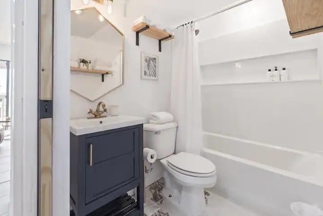 3938 Surfside Blvd Unit 1212, Corpus Christi, TX 78402 - bathroom with vanity, toilet, marble look tile flooring, and shower / tub combo