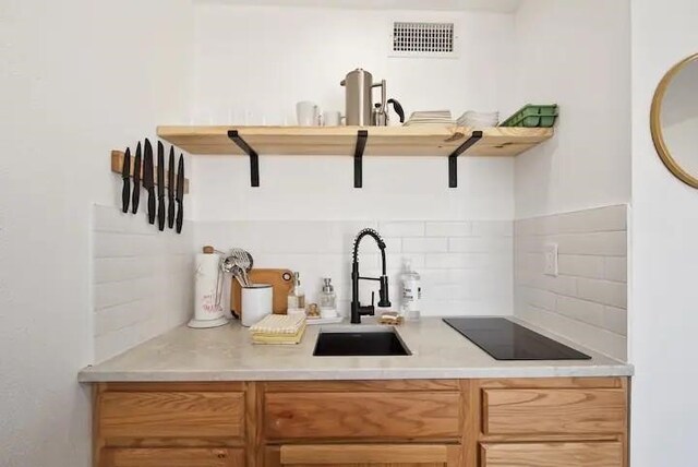 kitchen with sink, backsplash, and black electric cooktop