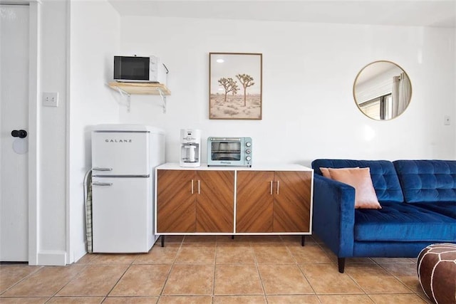 3938 Surfside Blvd Unit 1212, Corpus Christi, TX 78402 - kitchen with white appliances, brown cabinets, light countertops, light tile patterned flooring, and open floor plan