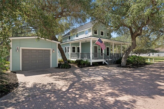 10 Old Cottage Beach Dr, Rockport, TX 78382 - view of front facade with a porch, an outbuilding, decorative driveway, and a garage