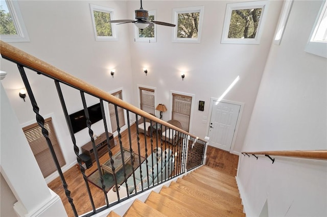 10 Old Cottage Beach Dr, Rockport, TX 78382 - staircase with a high ceiling, ceiling fan, wood finished floors, and baseboards