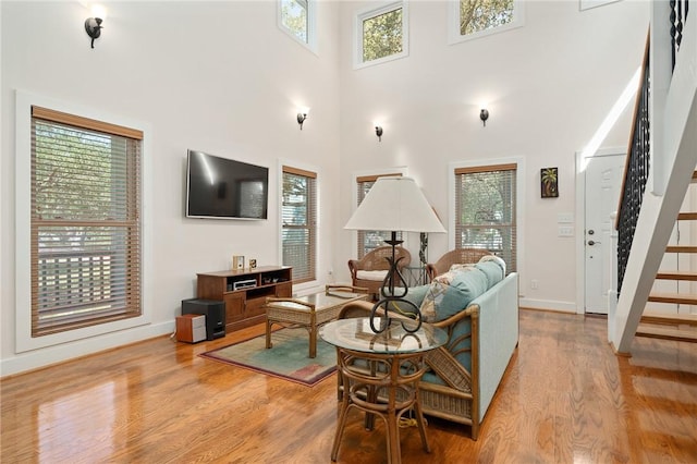 10 Old Cottage Beach Dr, Rockport, TX 78382 - living area with stairs, light wood finished floors, plenty of natural light, and a towering ceiling
