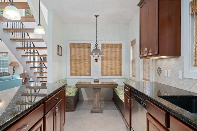 10 Old Cottage Beach Dr, Rockport, TX 78382 - kitchen featuring stainless steel dishwasher, tasteful backsplash, light tile patterned floors, and hanging light fixtures