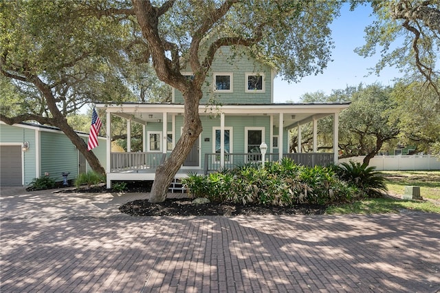 view of front of house with a porch, a garage, and an outdoor structure