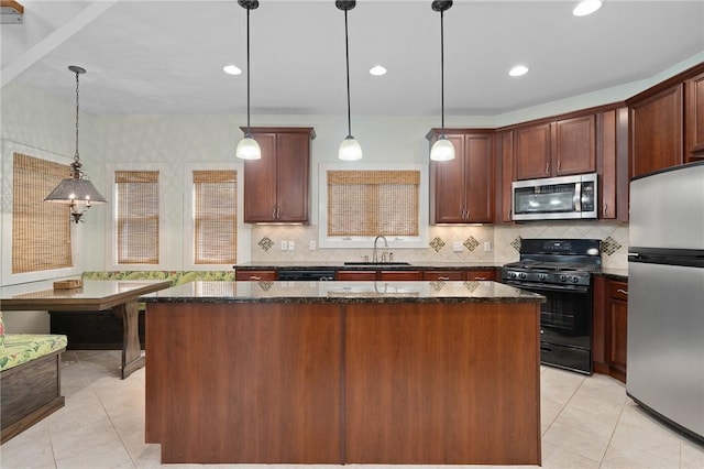 10 Old Cottage Beach Dr, Rockport, TX 78382 - kitchen featuring black appliances, a sink, light tile patterned flooring, a kitchen island, and recessed lighting