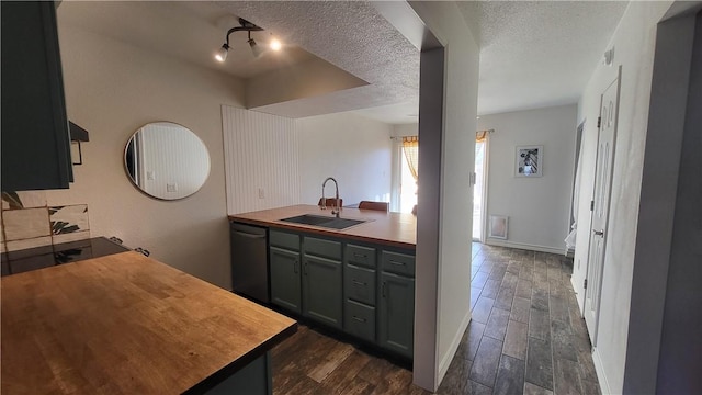 kitchen featuring a textured ceiling, dark wood-style flooring, a sink, black dishwasher, and wooden counters