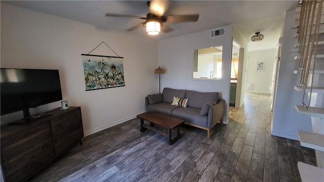 living room with a ceiling fan, baseboards, visible vents, and wood finished floors