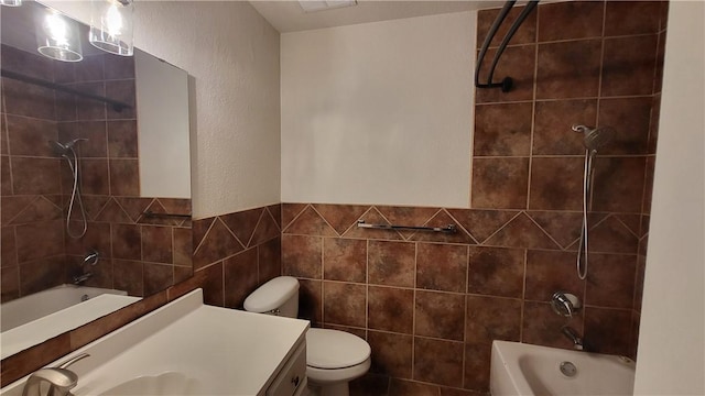 full bathroom featuring toilet, shower / bathing tub combination, tile walls, and vanity