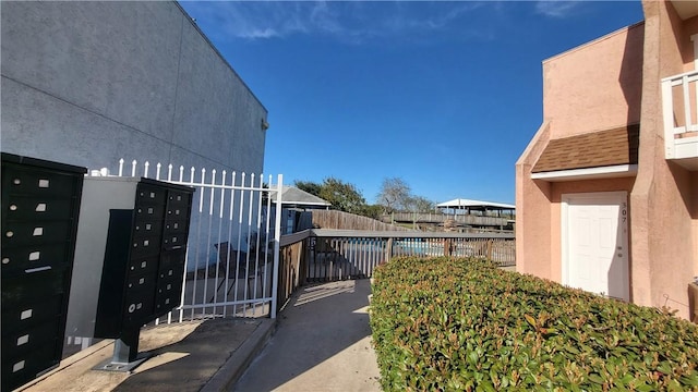 exterior space featuring fence and mail area