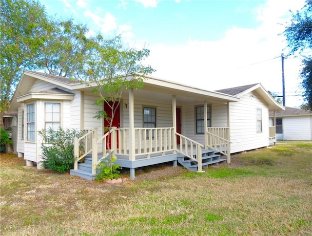 view of front of home featuring covered porch and a front yard