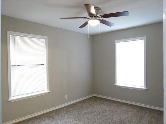 spare room featuring ceiling fan, a healthy amount of sunlight, and carpet flooring