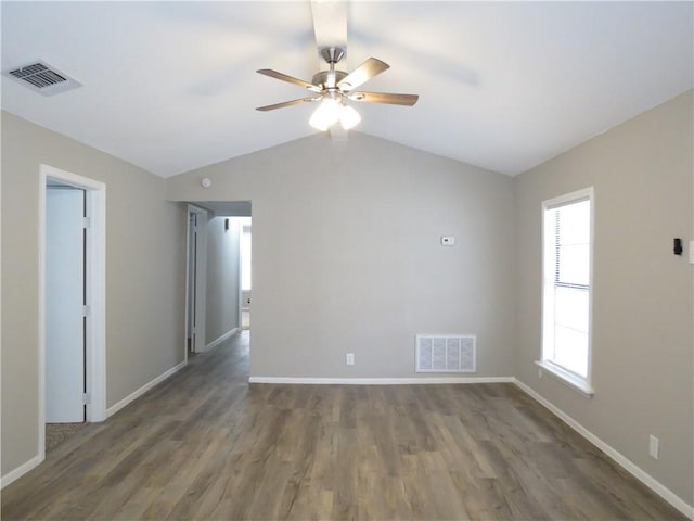 spare room with ceiling fan, lofted ceiling, and dark hardwood / wood-style floors